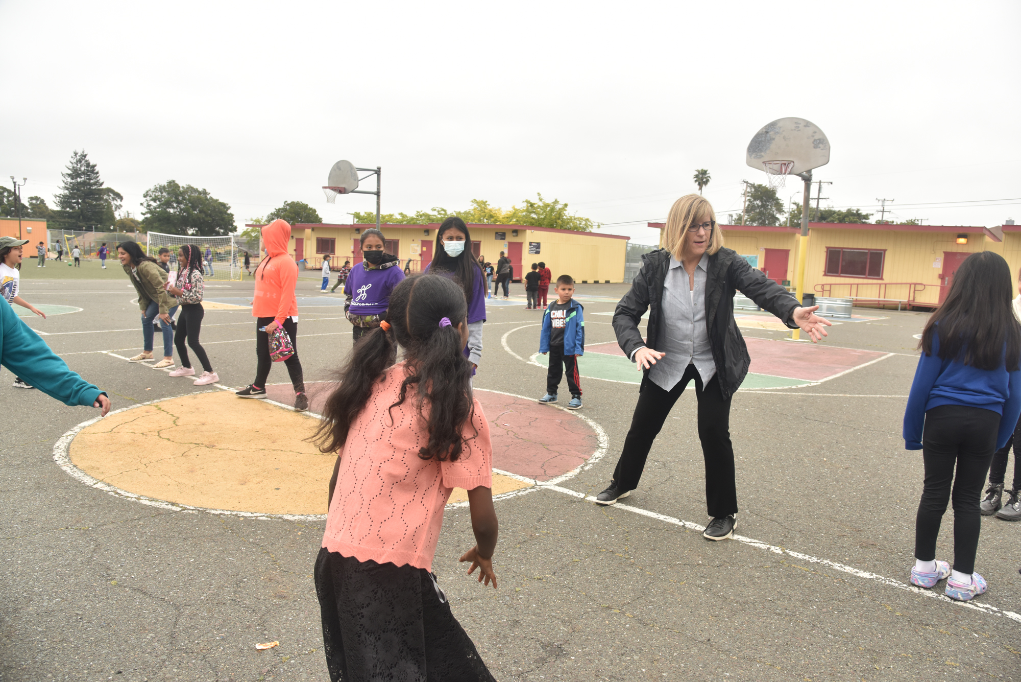 adult and students playing games