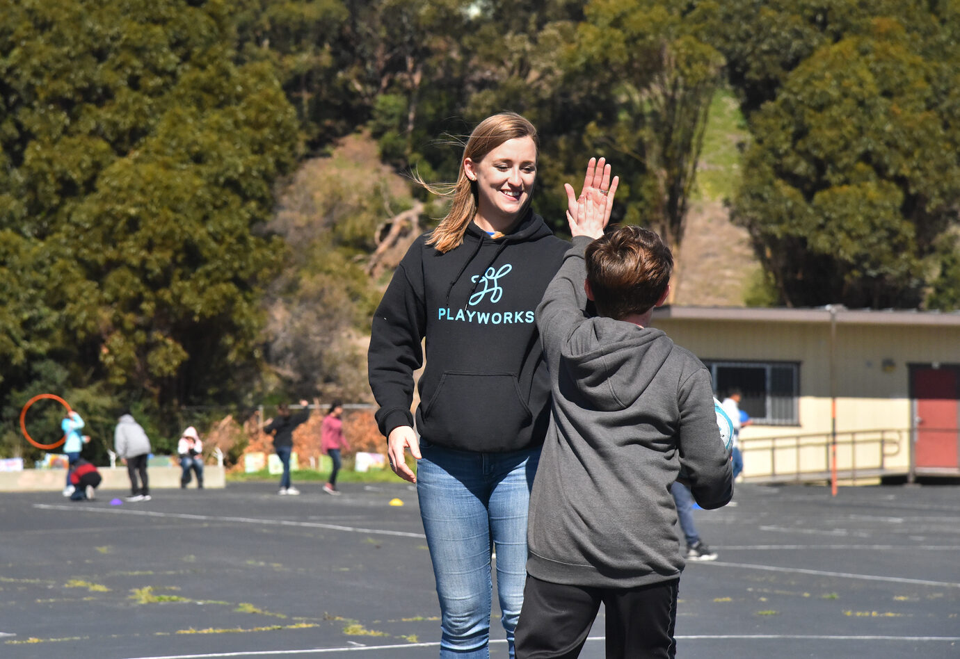 coach high-fiving student