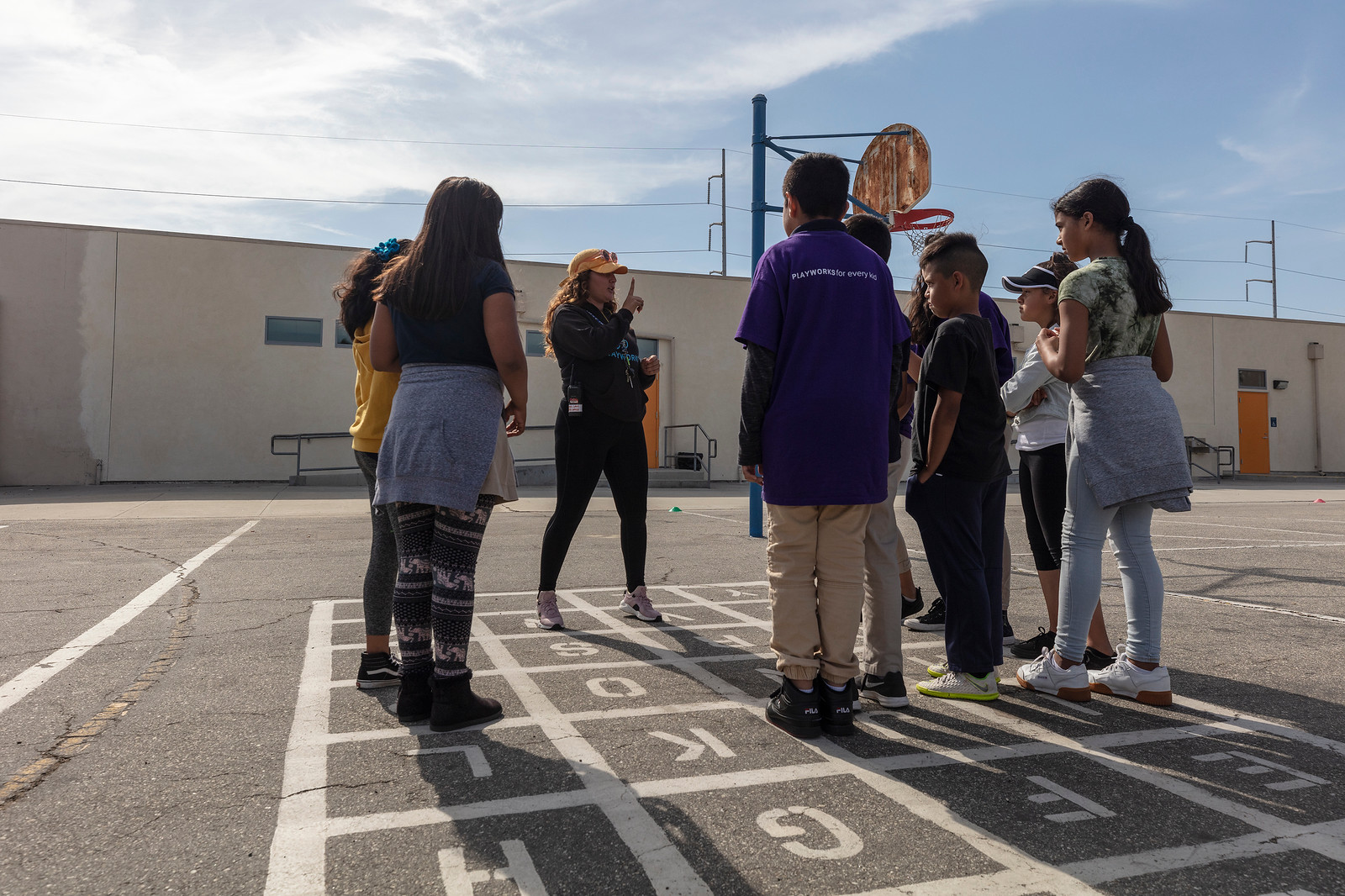 coach instructing students on blacktop