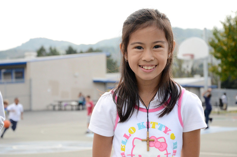 girl smiling on blacktop