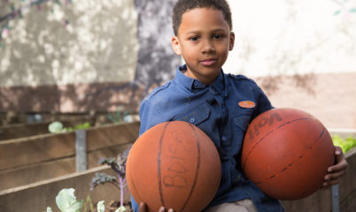 boy holding basketballs