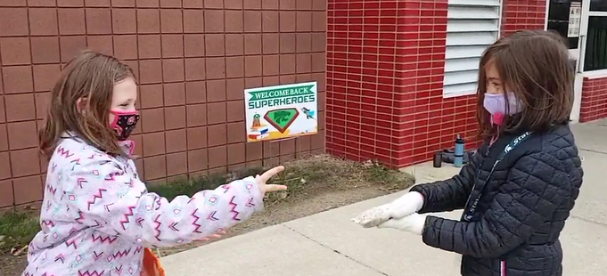 two girls playing rock paper scissors